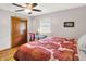 Bright bedroom with hardwood floors, closet, and window with natural light at 1225 N Graham Ave, Indianapolis, IN 46219