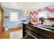 Inviting bedroom with hardwood floors, a decorative light fixture, and a cozy, kid-friendly design at 1225 N Graham Ave, Indianapolis, IN 46219