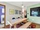 Dining room featuring modern table and bench with stylish decor and access to the laundry area at 1225 N Graham Ave, Indianapolis, IN 46219