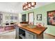 Kitchen island with seating adjacent to dining area; open concept kitchen and dining layout at 1225 N Graham Ave, Indianapolis, IN 46219