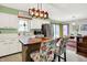 Bright kitchen showcasing white cabinets, stainless steel appliances, island with seating, and an adjacent dining area at 1225 N Graham Ave, Indianapolis, IN 46219