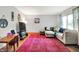 Inviting living room with hardwood floors, a comfortable sectional, and a large window at 1225 N Graham Ave, Indianapolis, IN 46219