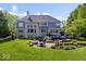 Spacious backyard with patio, deck, and manicured landscaping at 12399 Lynnwood Blvd, Carmel, IN 46033