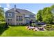View of the home's backyard with patio, deck and lush landscaping at 12399 Lynnwood Blvd, Carmel, IN 46033
