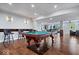 Finished basement with a pool table, bar stools, a kitchen, and a living room at 12399 Lynnwood Blvd, Carmel, IN 46033