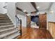 Finished basement entrance with barn doors and carpeted stairs at 12399 Lynnwood Blvd, Carmel, IN 46033