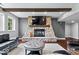 Basement living room with stone fireplace, a flat-screen TV, and large windows at 12399 Lynnwood Blvd, Carmel, IN 46033