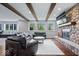 Basement living room with stone fireplace, large windows, and comfortable seating at 12399 Lynnwood Blvd, Carmel, IN 46033
