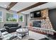 Basement Gathering room featuring stone fireplace and large window at 12399 Lynnwood Blvd, Carmel, IN 46033
