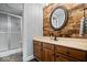 Bathroom with wood accent wall, vanity with sink, and glass door shower at 12399 Lynnwood Blvd, Carmel, IN 46033