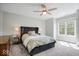 Bedroom featuring a ceiling fan, neutral walls, carpet flooring, and a plush bed at 12399 Lynnwood Blvd, Carmel, IN 46033