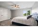 Relaxing bedroom with a ceiling fan, neutral decor, and a bed with decorative pillows at 12399 Lynnwood Blvd, Carmel, IN 46033