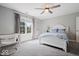 Cozy bedroom with a large window, ceiling fan, carpet flooring, and a classic style bed at 12399 Lynnwood Blvd, Carmel, IN 46033
