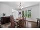 Bright dining room features hardwood floors, modern light fixture and is adjacent to an adjacent seating area at 12399 Lynnwood Blvd, Carmel, IN 46033