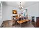 Dining room features a modern wood table, contemporary chandelier, hardwood floors and stylish decor at 12399 Lynnwood Blvd, Carmel, IN 46033