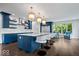 Modern kitchen with blue island, marble counters, and stainless appliances at 12399 Lynnwood Blvd, Carmel, IN 46033