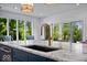Kitchen island with marble countertop and stainless steel sink at 12399 Lynnwood Blvd, Carmel, IN 46033