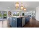 Kitchen island with marble countertop and stainless steel appliances at 12399 Lynnwood Blvd, Carmel, IN 46033