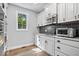 Kitchen with white cabinets, subway tile, stainless appliances and wood floors at 12399 Lynnwood Blvd, Carmel, IN 46033