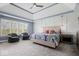 Spacious main bedroom with tray ceilings, sitting area, and large windows at 12399 Lynnwood Blvd, Carmel, IN 46033