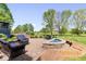 Stone patio with fire pit and outdoor seating overlooking the lawn at 12399 Lynnwood Blvd, Carmel, IN 46033