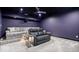 Basement media room with tiered seating, projector and dark purple walls at 12399 Lynnwood Blvd, Carmel, IN 46033