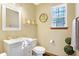 Bright half bathroom featuring a vanity, toilet, mirror, and decorative wall art at 125 W Chalet Dr, Mooresville, IN 46158