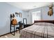 Light-filled bedroom with neutral walls, a bed, and desk with natural light from a window at 125 W Chalet Dr, Mooresville, IN 46158