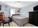 Light-filled bedroom with neutral walls, a bed, and a dark dresser, and natural light from a window at 125 W Chalet Dr, Mooresville, IN 46158