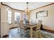 Cozy dining room with natural light, chandelier, wooden table, and decorative sign at 125 W Chalet Dr, Mooresville, IN 46158