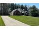 Charming home with a spacious yard, mature trees, and an American flag waving in the breeze at 125 W Chalet Dr, Mooresville, IN 46158