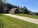 Well-maintained home with an expansive lawn, long driveway, and mature trees at 125 W Chalet Dr, Mooresville, IN 46158