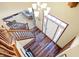 Entryway with hardwood floors, stairs with wood railing, and a front door with sidelights at 125 W Chalet Dr, Mooresville, IN 46158