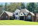 Charming two-story home with a well-manicured lawn and a brick and white exterior at 125 W Chalet Dr, Mooresville, IN 46158