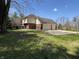 Spacious three-car garage and basketball court, surrounded by mature trees at 125 W Chalet Dr, Mooresville, IN 46158