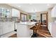 Modern kitchen with breakfast bar, stainless steel appliances, ample cabinet space and wooden floor at 125 W Chalet Dr, Mooresville, IN 46158