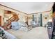Cozy living room with a fireplace, staircase, neutral furniture and wood trim at 125 W Chalet Dr, Mooresville, IN 46158