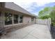 Private back patio with tan brick and view of fenced yard provides an inviting space for outdoor relaxation at 1297 Morningside Dr, Greenfield, IN 46140