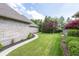 The backyard features a professionally landscaped lawn with mature trees and defined mulch beds at 1297 Morningside Dr, Greenfield, IN 46140