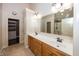 Bathroom featuring double sinks and large mirror, with entrance to walk-in closet and shower at 1297 Morningside Dr, Greenfield, IN 46140