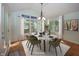 A dining room area with a modern table, arched ceiling, decorative windows and wood floors at 1297 Morningside Dr, Greenfield, IN 46140
