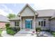 Charming brick home front entrance with a decorative blue door and well-maintained landscaping at 1297 Morningside Dr, Greenfield, IN 46140