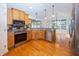 Charming kitchen featuring stainless steel appliances, wood cabinets, and hardwood floors at 1297 Morningside Dr, Greenfield, IN 46140
