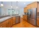 Bright kitchen with stainless steel appliances, wood cabinets, and hardwood floors at 1297 Morningside Dr, Greenfield, IN 46140