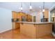 Well-lit kitchen featuring light wood cabinets, hardwood floors, and a center island with a sink at 1297 Morningside Dr, Greenfield, IN 46140