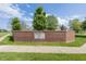Exterior shot of the brick Cricket Reel neighborhood sign with trees in the background and a sidewalk in front at 1297 Morningside Dr, Greenfield, IN 46140