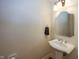 Elegant powder room boasts a pedestal sink with a decorative mirror, offering a touch of sophistication at 1297 Morningside Dr, Greenfield, IN 46140