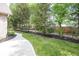 A manicured lawn with a concrete sidewalk surrounded by lush trees and landscaping bordering the home at 1297 Morningside Dr, Greenfield, IN 46140