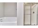 Bathroom with a white soaking tub and glass-enclosed shower at 13499 Molique Blvd, Fishers, IN 46037