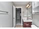 Bathroom with dark cabinets, medicine cabinet, and a view of a hallway leading to another room at 13499 Molique Blvd, Fishers, IN 46037